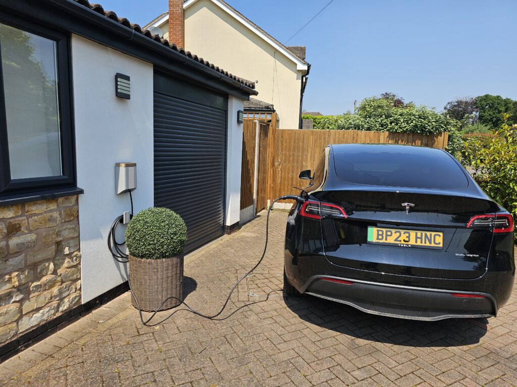 Tesla Model Y Simpson & Partners EV Charger 7kW fixed to front of house