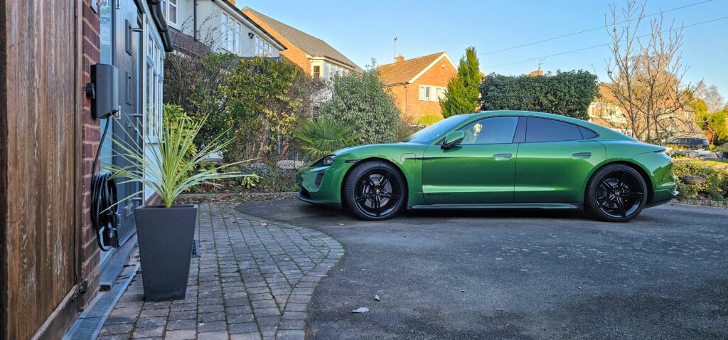 Green Porsche Taycan on charge with a Andersen Quartz in grey