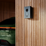 Zaptec_go2_home_charging_1153 Zaptec fixed on a wooden wall with green car in the backgrounmd